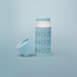 Load image into Gallery viewer, Noz&#39; blue nose sunscreen with the cap open and leaning up against the side of the cylinder sunscreen container, with a light blue background.
