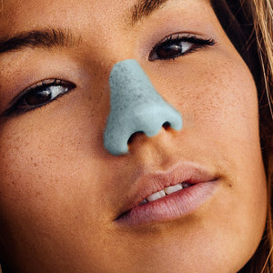 Young female wearing Noz' blue nose sunscreen